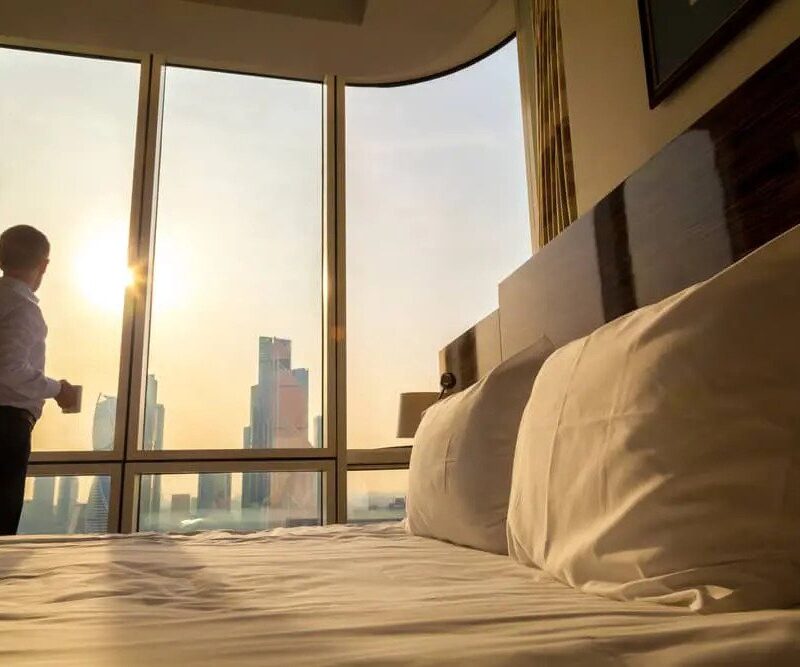 Person looking at the sunrise from a hotel window