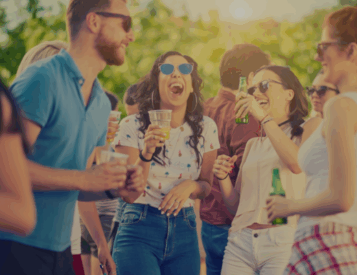 colleagues enjoying drinks outside at a summer party