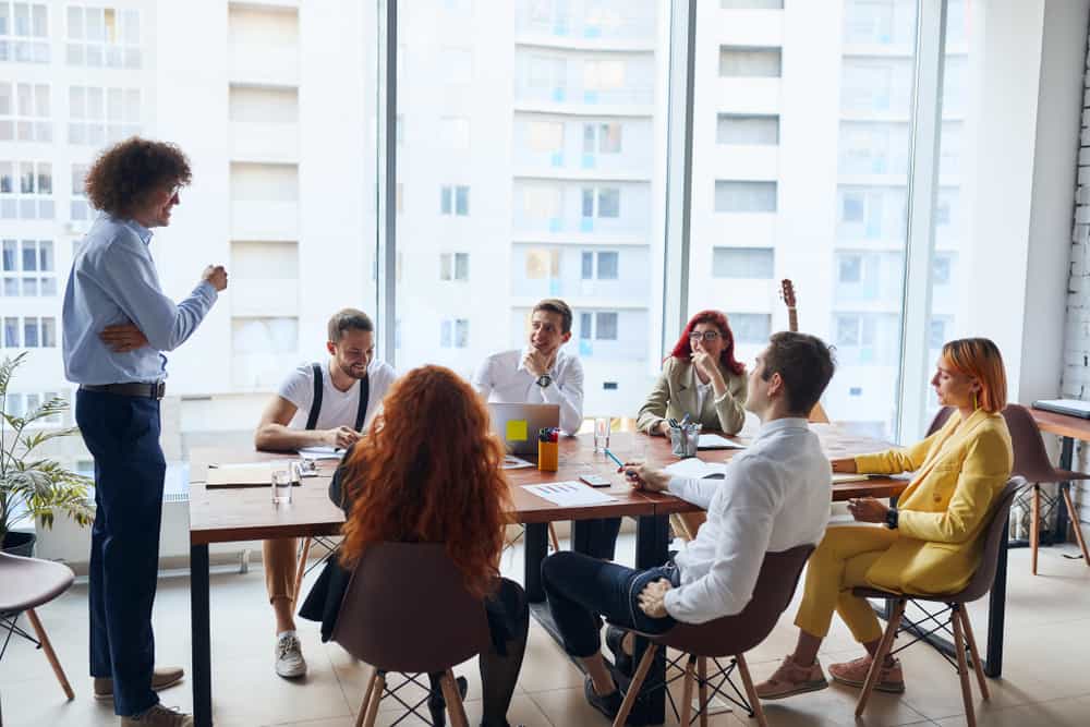 seven young business people taking a meeting