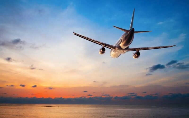 A plane mid flight, at dusk