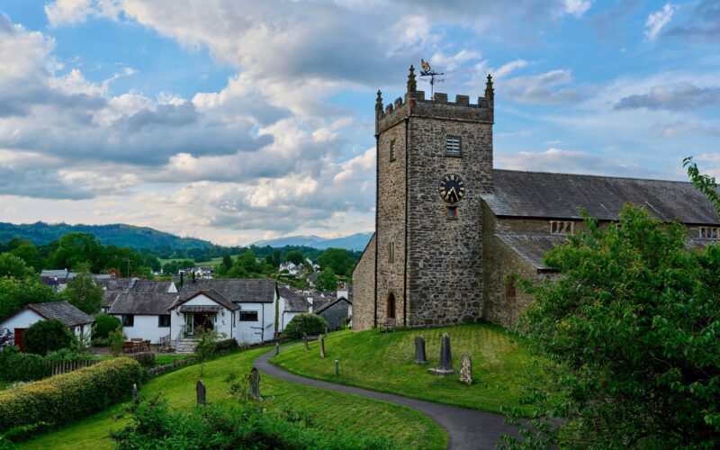 Charming stone church with clock tower in the tranquil Lake District, England.
